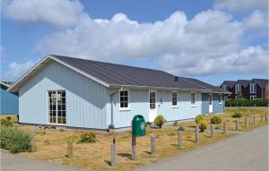 a white building with a black roof at Apartment Lønne Feriepark , Seawest M-941 in Lønne Hede
