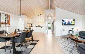 a kitchen and living room with a table and chairs at 2 Bedroom Amazing Apartment In Slagelse in Slagelse
