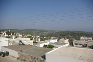 a person sitting on top of a roof with a skateboard at Manos House in Monólithos