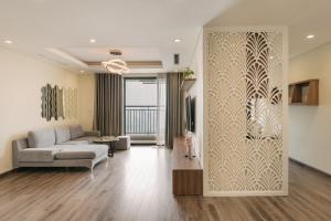 a living room with a couch and a wall mural at H-Vista Suites - Hongkong Tower in Hanoi