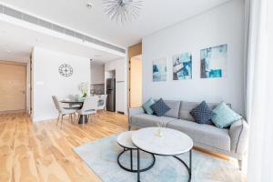 a living room with a couch and a table at Address Beach Residences in Dubai