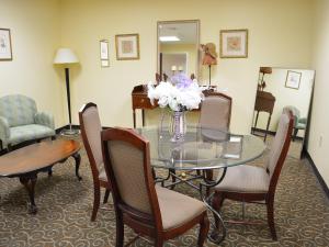 a dining room with a glass table and chairs at Baymont by Wyndham East Windsor Bradley Airport in East Windsor