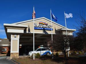 a building with a car parked in front of it at Baymont by Wyndham East Windsor Bradley Airport in East Windsor