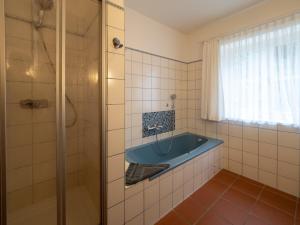 a bathroom with a tub and a shower at Kaapdüne in Spiekeroog +32 photos