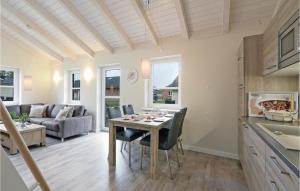 a kitchen and living room with a table and chairs at Gorgeous Home In Dagebüll With Wifi in Dagebüll