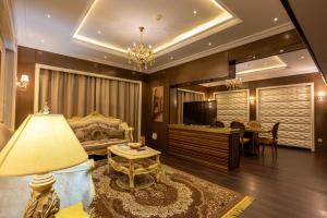 a living room with a couch and a table at Ras Al Khaimah Hotel in Ras al Khaimah