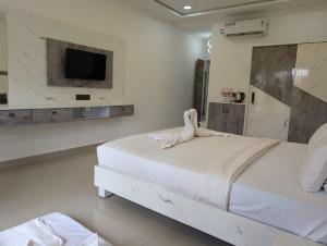 Voodi või voodid majutusasutuse Shaan Coco Palms Beach Resort toas