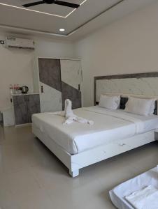Voodi või voodid majutusasutuse Shaan Coco Palms Beach Resort toas