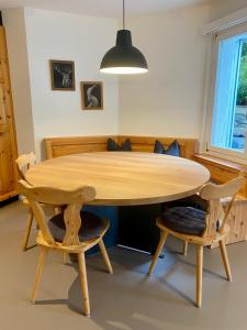 a wooden table with two chairs and a dining room at house & living junbi in Laax +17 photos