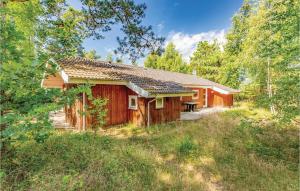 a log cabin in the woods with a picnic table at Holiday Home Hjortestien Højby X in Lumsås +17 photos