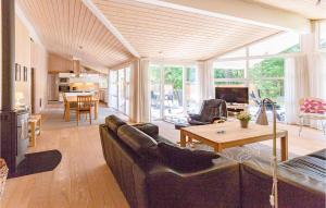 a living room with a couch and a table at Holiday Home Hjortestien Højby X in Lumsås