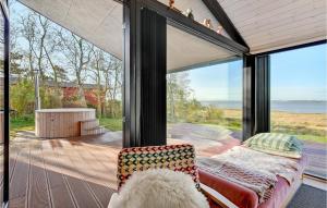 a glass house with a couch and a view of the ocean at Cozy Home In Højslev With Wifi in Højslev
