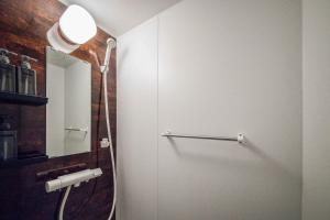 a bathroom with a shower stall and a mirror at THE CITYSCAPE in Kita-sanjō +67 photos