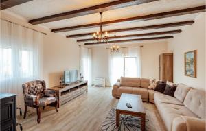 a living room with a couch and a tv at Amazing Home In Herceg Novi With Wifi in Herceg-Novi
