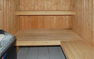 a inside of a sauna with a wooden wall at Holiday Home Guldvangen Nørre Nebel I in Lønne Hede