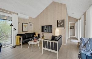 a living room with a couch and a table at 3 Bedroom Pet Friendly Home In Oksbøl in Oksbøl