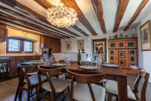 a dining room with a table and chairs and a chandelier at Supersaxo QUIET & CHARMING chalet 8 pers in Agettes