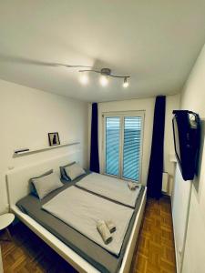 a bedroom with a bed with a television and a tv at Jenny Apartment with Jacuzzi in Brezovica