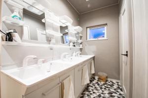 a bathroom with two sinks and a mirror at THE SUN LOUNGE in Kushiro +88 photos