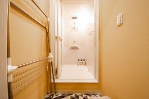 a small bathroom with a shower and a toilet in a room at THE SUN LOUNGE in Kushiro