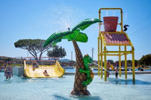 a fake palm tree in the water at a water park at Glamping Aglientu in Vignola Mare