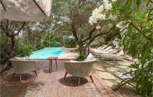 a wooden deck with chairs and a swimming pool at Rupe Alta in Castellabate