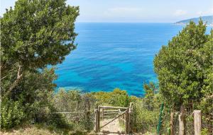 an open gate with the ocean in the background at Rupe Alta in Castellabate