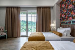 a hotel room with two beds and a window at Macara Village Resort in Quba +92 photos