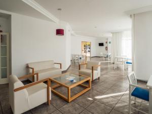 a living room with a table and chairs at Apartamentos La Santa Maria in Cala Millor