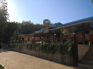 a building with a fence and stairs in front of it at Campchamao in Ban Ra-ok