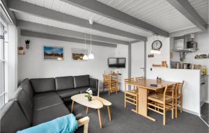 a living room with a couch and a table at Nice Apartment In Hemmet With Sauna in Hemmet
