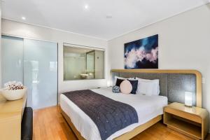 a bedroom with a large bed and a desk at Salt Beach Resort Apartments by Kingscliff Accommodation in Kingscliff