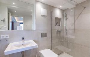 a bathroom with a sink and a shower and a toilet at Sunny in Binz