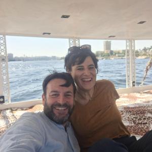 a man and woman sitting on the back of a boat at Mama Africa Felucca in Aswan +8 photos