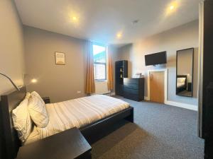 a bedroom with a bed and a television in it at 1 bed Apt close to Leeds Arena Sleeps up to 4 people F1 in Leeds