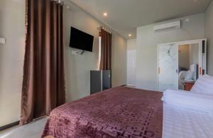 Μια τηλεόραση ή/και κέντρο ψυχαγωγίας στο Villa Rose 1 Sanur