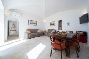 a living room with a table and a couch at Torre del Califfo Amalfi Relais in Amalfi