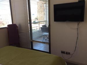um quarto com uma cama e uma televisão de ecrã plano em Reñaca Park Apartment em Viña del Mar