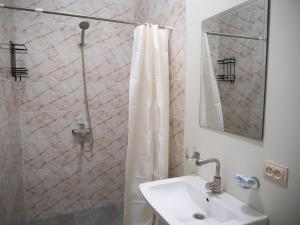 a bathroom with a sink and a shower at kutaisi base camp in Kutaisi +47 photos