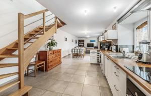 une cuisine avec des placards blancs et un escalier dans l'établissement Gorgeous Home In Saint-Méloir-Des-Ondes, à Saint-Méloir-des-Ondes 14 autres photos
