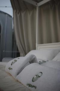a woman laying on a bed with a towel at Glamping & Spa Luna Azzurra in Sulmona