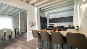 a kitchen and dining room with a table and chairs at Villa Sirmione Front Lake in Sirmione
