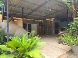 an outside view of a building with a patio at Campchamao in Ban Ra-ok
