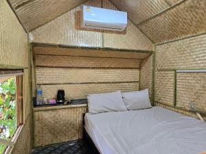 a room with a bed in a small room at Campchamao in Ban Ra-ok