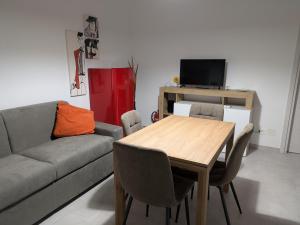 a living room with a table and a couch at Casa Stefania in Collegno