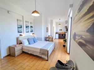 a bedroom with a bed with blue pillows at Porto Diakofti in Diakofti