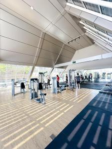 a building with a gym with people on machines at Family Suite at Landmark Residence in Bandung