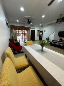 a living room with a yellow couch and chairs at D23 Homestay Bandar Baru Bangi, Selangor in Bandar Baru Bangi +33 photos