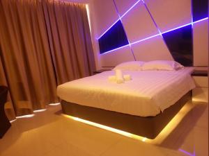 Postel nebo postele na pokoji v ubytování Hotel Vevo Puchong Malaysia