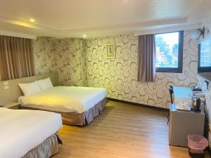 Postel nebo postele na pokoji v ubytování Jin Tsai Shen Hotel